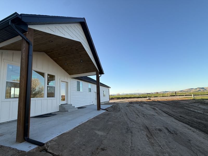 Covered back patio with timber posts and valley views