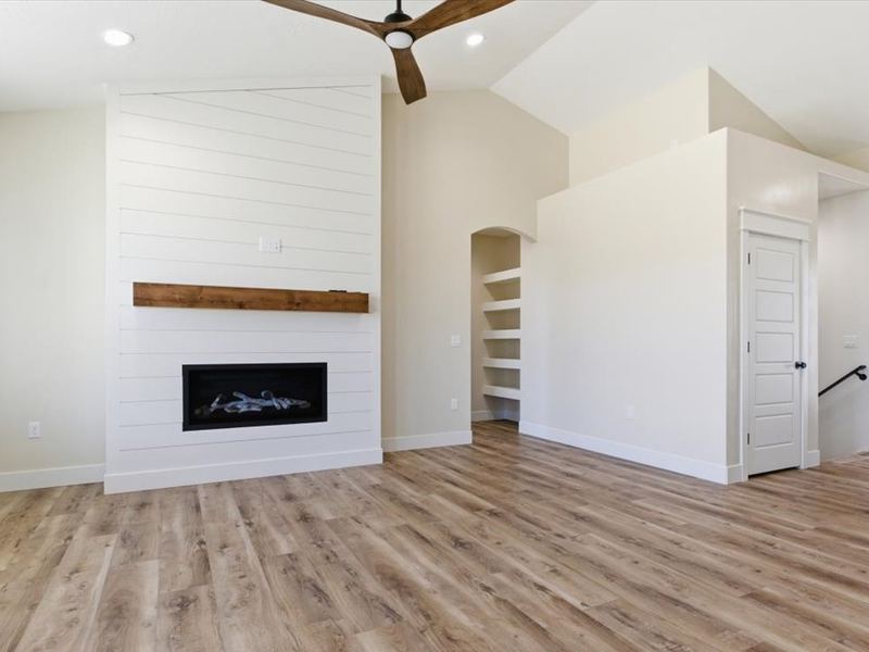 Great room with a linear fireplace and wood mantel