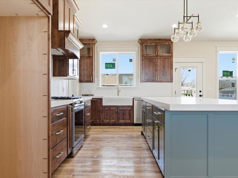 Kitchen island with pendant lights and seating, open to the dining area