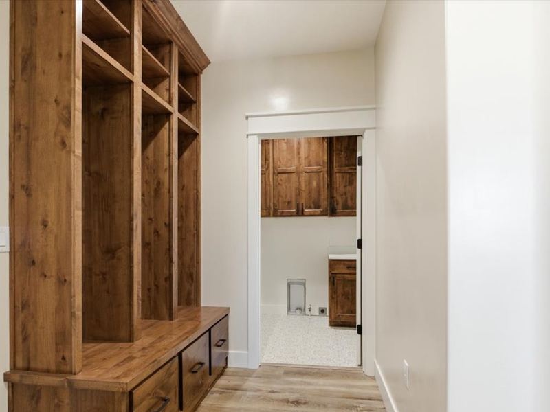 Mudroom with built-in wood lockers and bench