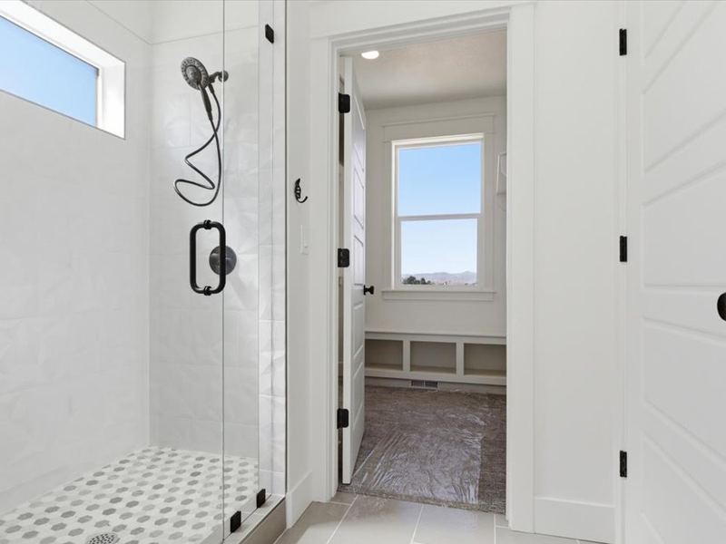 Tiled walk-in shower with matte black fixtures