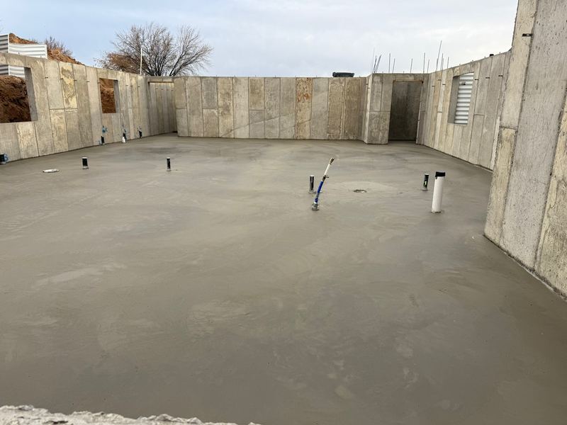 Finished concrete basement slab inside the foundation walls