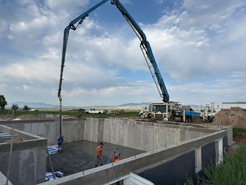 Concrete pump truck placing a pour on a basement