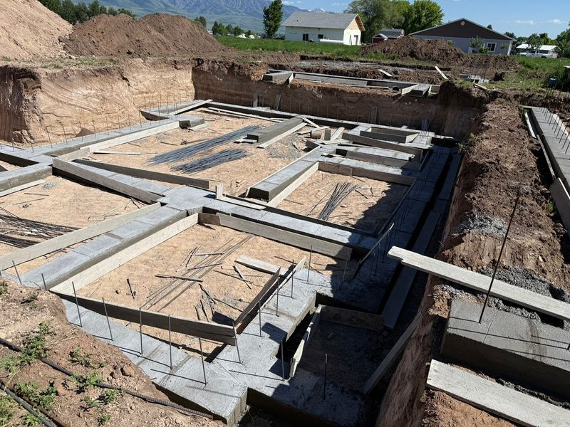 Footing forms laid out across a new basement excavation