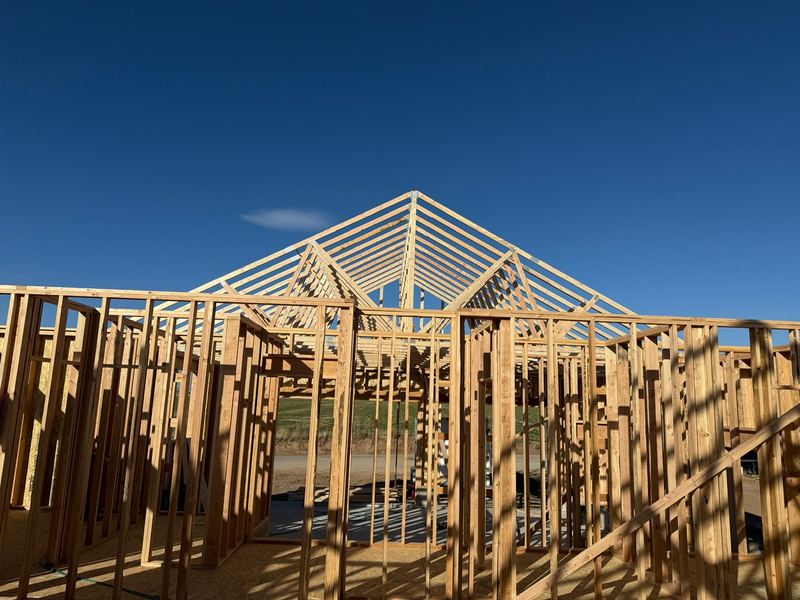 Roof trusses going up on a wood-framed home