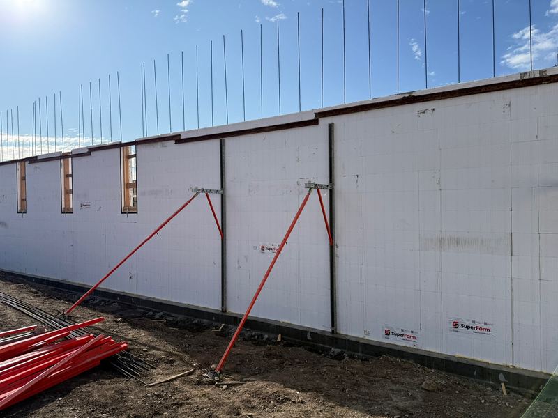 Tall ICF walls braced and aligned before the pour