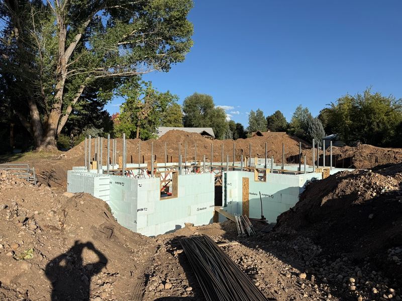 ICF foundation walls standing in the excavation, ready for backfill