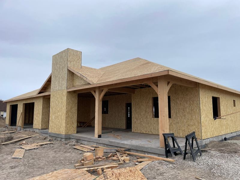 Silver Spurs custom home with a covered timber porch, during framing