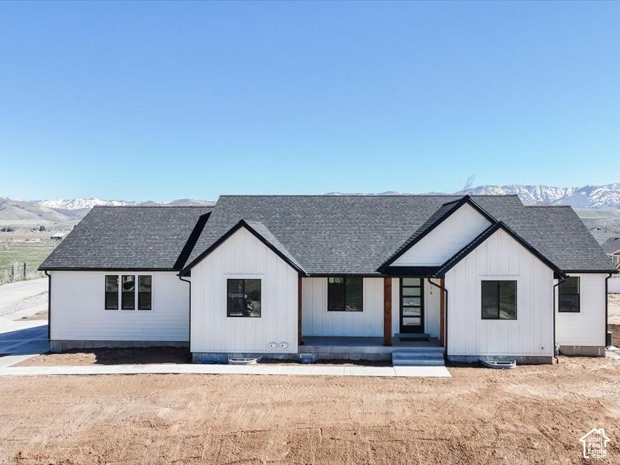 Front exterior of 816 S 1100 E, Preston, Idaho, a white single-level home with a dark roof