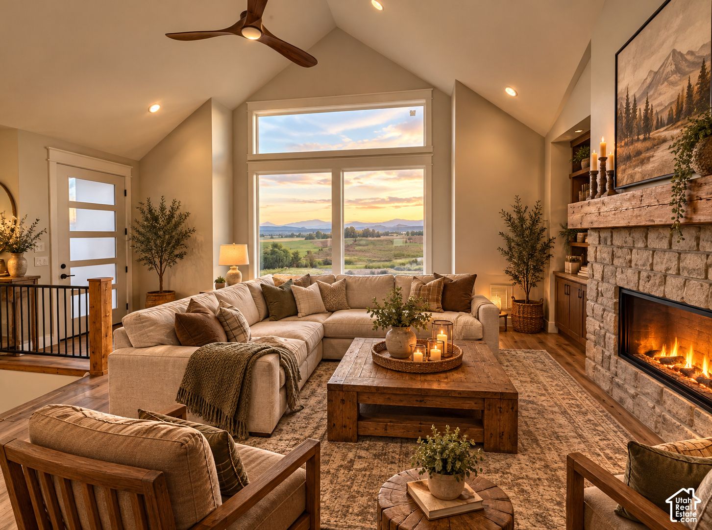 Vaulted great room at 832 S 1100 E, Preston, Idaho, with a stone fireplace and large windows